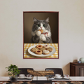 Framed print of a whimsical oil-painting-style portrait showing a grey and white cat eating a cookie at a checkered table.