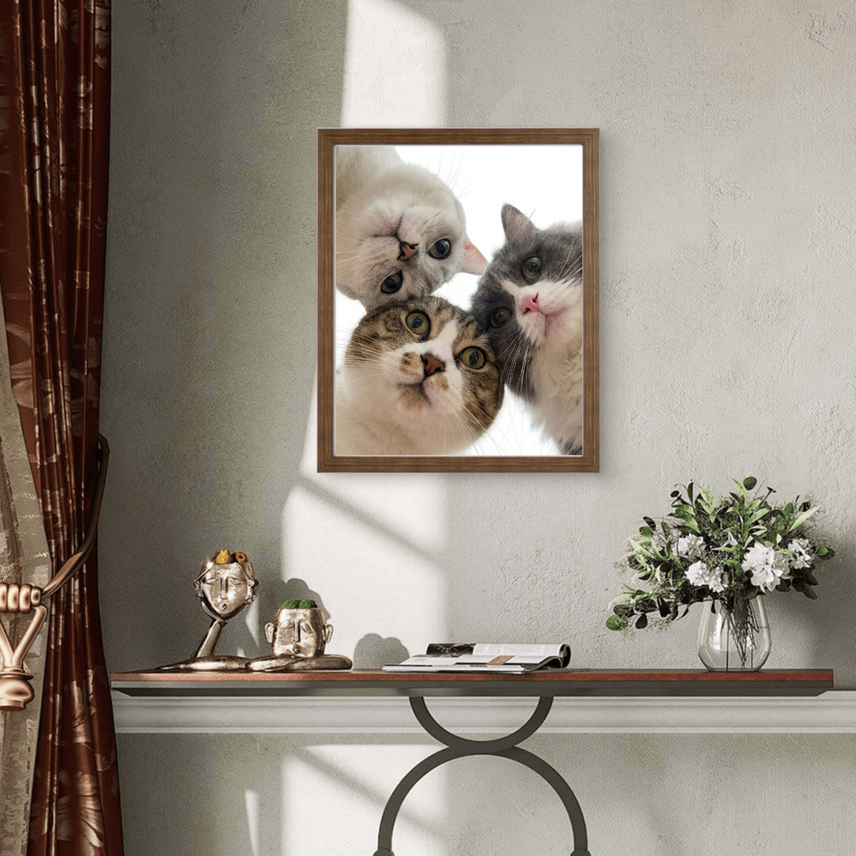 Framed print of a realistic pet portrait featuring three cute cats looking down, set against a bright, minimalist background.