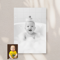 Framed Artzuzu Bubble Bliss portrait of a smiling baby with a rubber duck on their head in a bubble-filled bath.