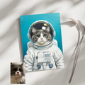 Framed oil painting print of a grey and white cat in an astronaut suit against a blue background, displayed on