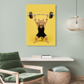 Framed wall art of an orange cat wearing a black tank top and shorts, powerlifting against a vibrant yellow background.