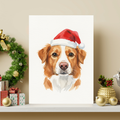Watercolor portrait of a dog wearing a Santa hat, displayed in a framed print on a shelf with festive Christmas