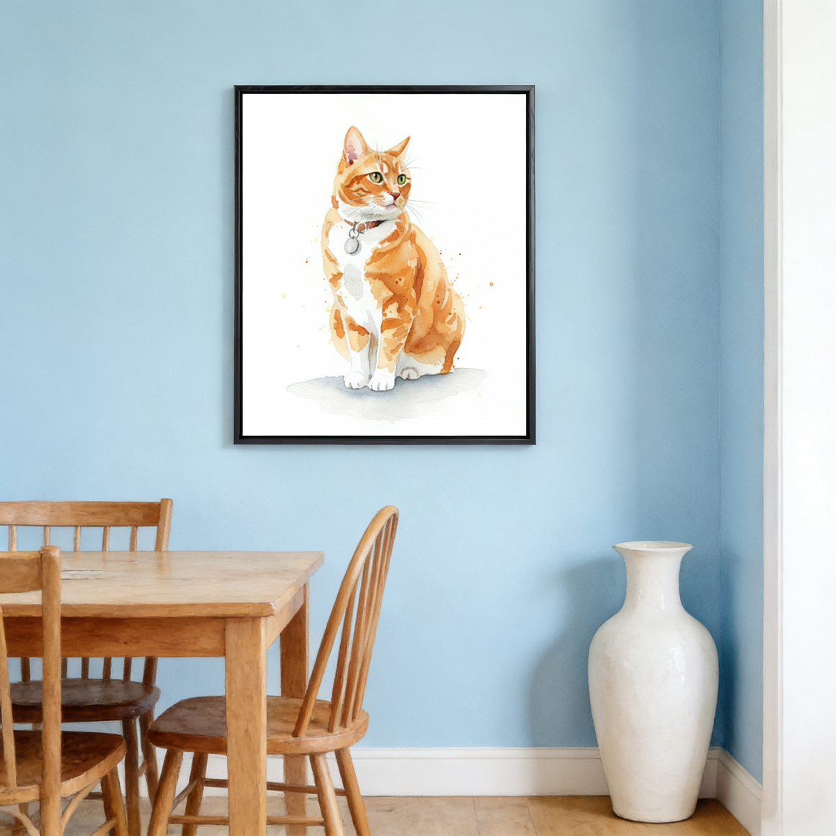 Framed watercolor portrait of an orange tabby cat displayed on a blue wall in a dining room setting.