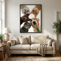 Framed Artzuzu custom pet portrait of a dog and three cats looking down, displayed on a living room wall.