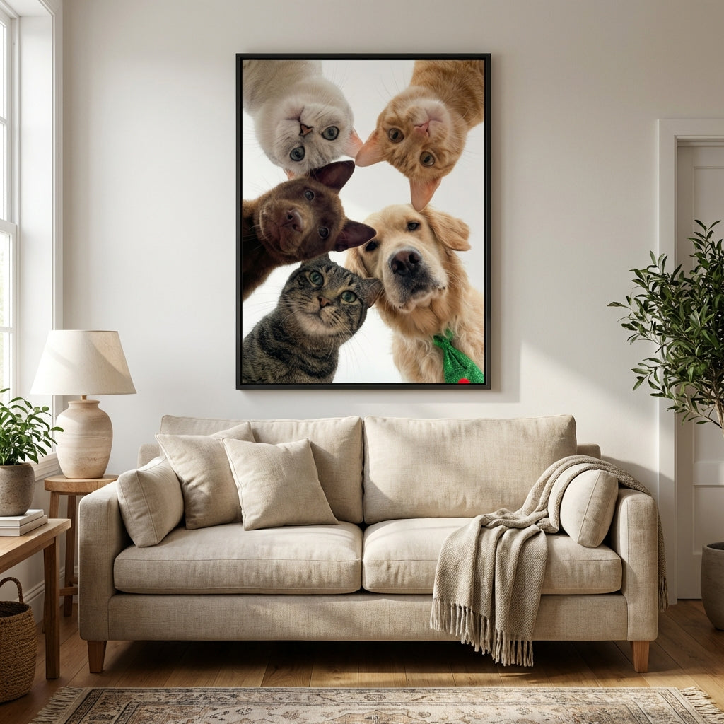 Framed Artzuzu custom pet portrait of a dog and three cats looking down, displayed on a living room wall.
