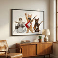 Framed artwork of cats playing music on a wall above a wooden cabinet.