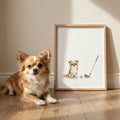 Framed watercolor portrait of a tan long-haired chihuahua with a golf ball and club, displayed in a sunny home setting.