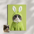 Framed print of a gray and white cat wearing a fuzzy mint-green bunny costume against a solid green background.