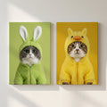 A wall-mounted set of two digital art portraits showing a grey cat in a green bunny suit and a tabby