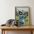 Framed print on a wooden table showing an oil-style portrait of a raccoon wearing a golf shirt and visor on